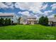 Expansive backyard with lush green lawn and two-story home in background at 4323 Bright Rd, Charlotte, NC 28214