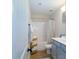 Cozy bathroom with blue vanity, tile floor, and shower-tub combo at 4323 Bright Rd, Charlotte, NC 28214