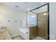 Bathroom features a tiled shower, soaking tub, and large window at 4323 Bright Rd, Charlotte, NC 28214