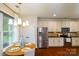 Charming dining area filled with natural light, featuring a wooden table and stainless appliances at 4323 Bright Rd, Charlotte, NC 28214