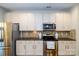 The kitchen offers stainless steel appliances, granite countertops, and sleek white cabinetry at 4323 Bright Rd, Charlotte, NC 28214