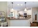 The open kitchen features granite countertops, stainless steel appliances, and pendant lighting at 4323 Bright Rd, Charlotte, NC 28214