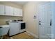 Well-equipped laundry room with washer, dryer, sink, and storage cabinets at 4323 Bright Rd, Charlotte, NC 28214
