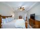 Spacious main bedroom with wood furniture, neutral walls, and a ceiling fan at 4323 Bright Rd, Charlotte, NC 28214