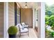 Relaxing covered porch featuring comfortable seating and decorative plants at 4323 Bright Rd, Charlotte, NC 28214