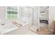 Bright bathroom featuring a soaking tub and glass-enclosed shower at 444 Battery Cir, Clover, SC 29710