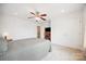 Spacious carpeted bedroom with a ceiling fan, TV on a shelf, and neutral walls at 444 Battery Cir, Clover, SC 29710