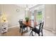 Bright breakfast nook with a wooden table, a decorative plant, and a view of the backyard at 444 Battery Cir, Clover, SC 29710