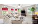 Sunlit living room featuring a comfortable sofa, large windows, and a ceiling fan at 444 Battery Cir, Clover, SC 29710