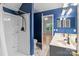 Bathroom featuring a shower, toilet, and double sink vanity with blue walls at 4557 Panther Pl, Charlotte, NC 28269