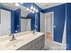 Bathroom with double sink vanity and blue accent wall at 4557 Panther Pl, Charlotte, NC 28269