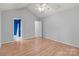 Bedroom with light gray walls, wood floors, and a ceiling fan at 4557 Panther Pl, Charlotte, NC 28269