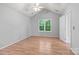 Bedroom with wood floors and a large window with a backyard view at 4557 Panther Pl, Charlotte, NC 28269