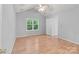 Bedroom with light gray walls and ceiling fan and view to backyard window at 4557 Panther Pl, Charlotte, NC 28269