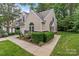 Exterior elevation showcasing townhome with landscaping, lawn, and neutral siding at 4557 Panther Pl, Charlotte, NC 28269