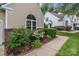 Exterior elevation showcasing townhome with garden bed and neutral siding at 4557 Panther Pl, Charlotte, NC 28269