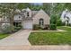 Charming home featuring a manicured lawn, attached garage, and beautiful landscaping at 4557 Panther Pl, Charlotte, NC 28269
