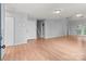 Open-concept living room with hardwood floors, neutral walls, and a welcoming atmosphere at 4557 Panther Pl, Charlotte, NC 28269