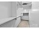 Organized walk-in closet with shelving, drawers, and hanging rods at 4557 Panther Pl, Charlotte, NC 28269