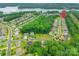Neighborhood aerial view showcasing homes, mature trees, and lake in the background, with property location marked at 5130 Watersail Way, Clover, SC 29710