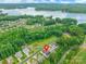 Aerial view showing a home's location near a lake and surrounded by lush greenery at 5130 Watersail Way, Clover, SC 29710