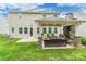 Back exterior view featuring a stone fireplace and comfortable outdoor seating at 5130 Watersail Way, Clover, SC 29710