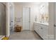 Bright bathroom with modern gray tiling, wooden accent table, and neutral walls at 5130 Watersail Way, Clover, SC 29710