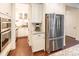 Bright kitchen with stainless steel appliances, white cabinets, and a view of the pantry at 5130 Watersail Way, Clover, SC 29710