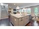 Kitchen island with granite countertop, stainless steel dishwasher, sink, and view of the staircase and living room at 5130 Watersail Way, Clover, SC 29710