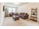 Inviting living room with comfortable seating, neutral carpet, and plenty of natural light from large windows at 5130 Watersail Way, Clover, SC 29710