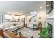 Spacious living room adjacent to a modern kitchen and featuring an open staircase at 5130 Watersail Way, Clover, SC 29710