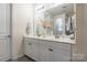 Modern main bathroom features a double sink vanity with white cabinets and a large mirror at 5130 Watersail Way, Clover, SC 29710