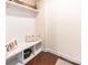 Functional mudroom with storage bench, white wainscoting, and decor at 5130 Watersail Way, Clover, SC 29710