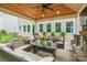 Covered outdoor space with fireplace and ample seating and outdoor greenery at 5130 Watersail Way, Clover, SC 29710