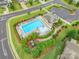 Aerial view of a community pool featuring lounge chairs, a splash pad, and well-maintained landscaping at 5130 Watersail Way, Clover, SC 29710