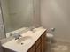 Bathroom featuring a dual-sink vanity, commode, and large mirror above the sinks at 5476 Ives Nw St, Concord, NC 28027