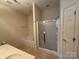 Primary bath includes a soaking tub, glass-enclosed shower and vanity at 5476 Ives Nw St, Concord, NC 28027