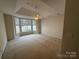 Large bedroom features plush carpet, bay window, and ceiling fan at 5476 Ives Nw St, Concord, NC 28027