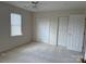 Bedroom featuring two closets, ceiling fan and a window with blinds at 5476 Ives Nw St, Concord, NC 28027
