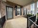 Charming front porch with brick facade, black shutters and railing at 5476 Ives Nw St, Concord, NC 28027