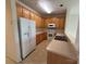 Bright kitchen features wooden cabinets, white appliances, and tile flooring at 5476 Ives Nw St, Concord, NC 28027