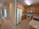 Bright kitchen features wooden cabinets, white appliances, and tile flooring at 5476 Ives Nw St, Concord, NC 28027