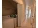 Functional laundry area equipped with a washer, dryer, and storage space near a hallway at 5476 Ives Nw St, Concord, NC 28027