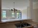 Open-concept living room features chandelier, large windows, and access to the porch at 5476 Ives Nw St, Concord, NC 28027