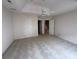 Spacious bedroom featuring a tray ceiling with ceiling fan and multiple doorways at 5476 Ives Nw St, Concord, NC 28027
