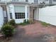 Exterior shot of the brick patio with a view of the windows and white fence at 5476 Ives Nw St, Concord, NC 28027
