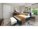 Cozy bedroom with a blue accent bed, complemented by neutral walls, art, and natural light from the window at 6033 Edinmeadow Ln, Charlotte, NC 28269