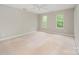 Spacious, carpeted bedroom with neutral walls and natural light from dual windows, ready for personalization at 6033 Edinmeadow Ln, Charlotte, NC 28269
