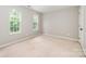 Bright bedroom with neutral walls, carpeting, and natural light from two windows at 6033 Edinmeadow Ln, Charlotte, NC 28269