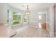Bright dining area has tile flooring, a decorative chandelier, and large windows that offer a pleasant view at 6033 Edinmeadow Ln, Charlotte, NC 28269